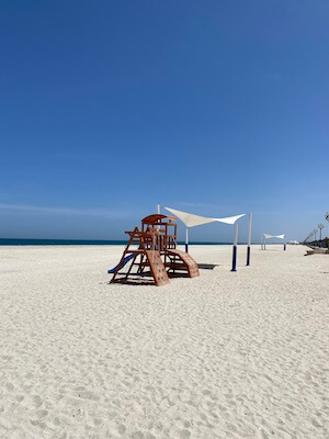 beach and play area at kalba corniche development