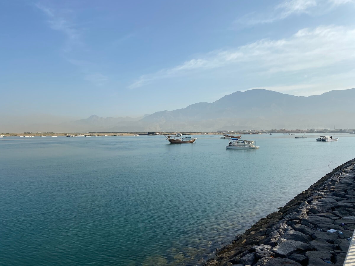 view of Rams bay and corniche from pier with mountaisn in background
