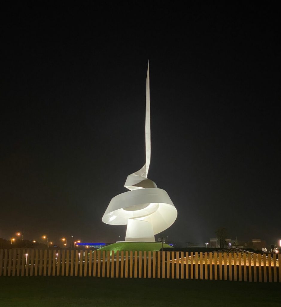 the scroll monument sharjah at night