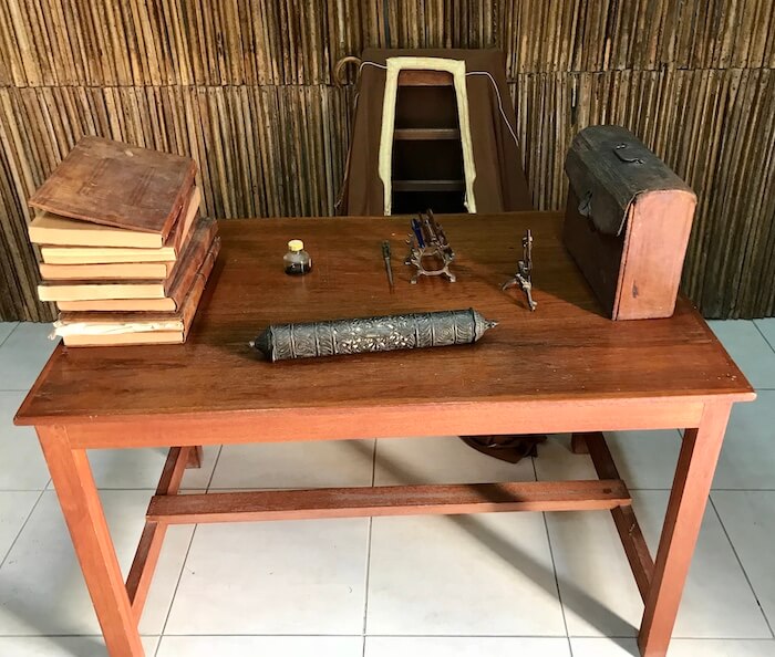 Teacher's desk with books and implements at Al Eslah school museum
