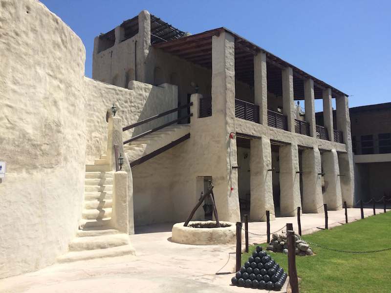 Umm al Quwain Museum and Fort inner courtyard  with a well and cannonball