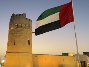 Photo of a fort and UAE flag linking to the UAE history and heritage page