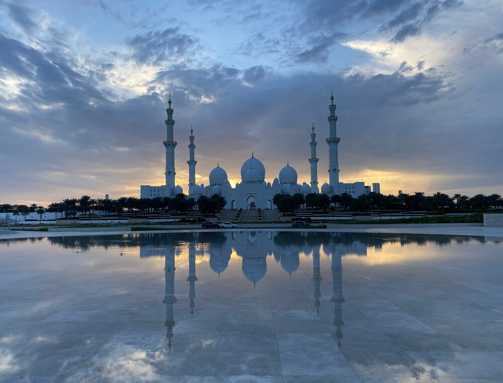 photo of reflection of sheikh zayed mosque in pond at Wahat Al Karama