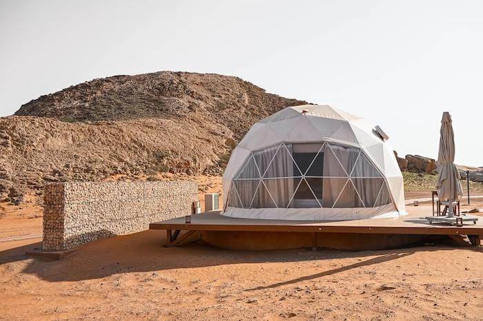 glamping pod on plains with mountain behind, moon retreat uae, sharjah sustainable toursim