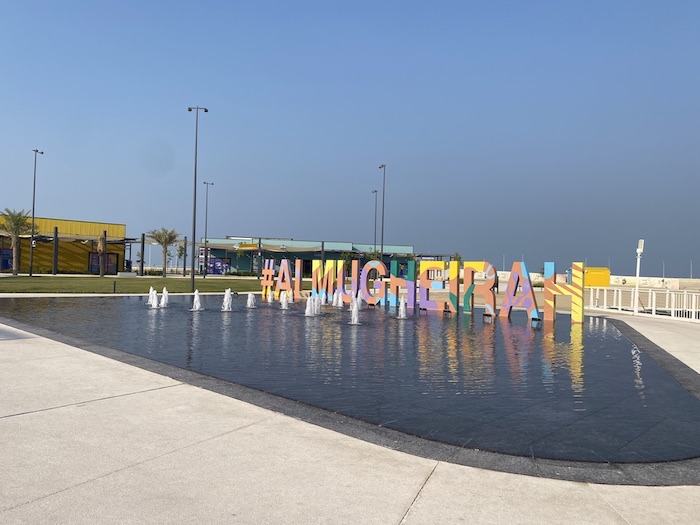 al mugheirah waterfront with colourful sign mirfa
