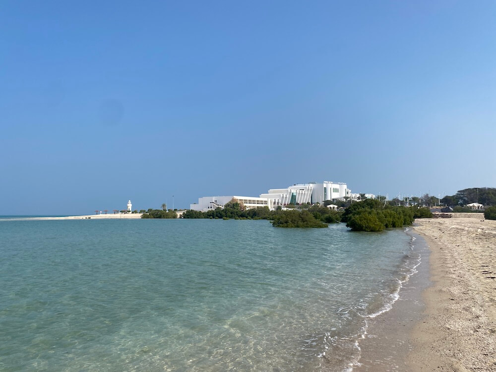 Beach at Mirfa next to mangroves. Golden sand with crystal clear turquoise sea. Mirfa Hotel in the background. Mirfa things to Do