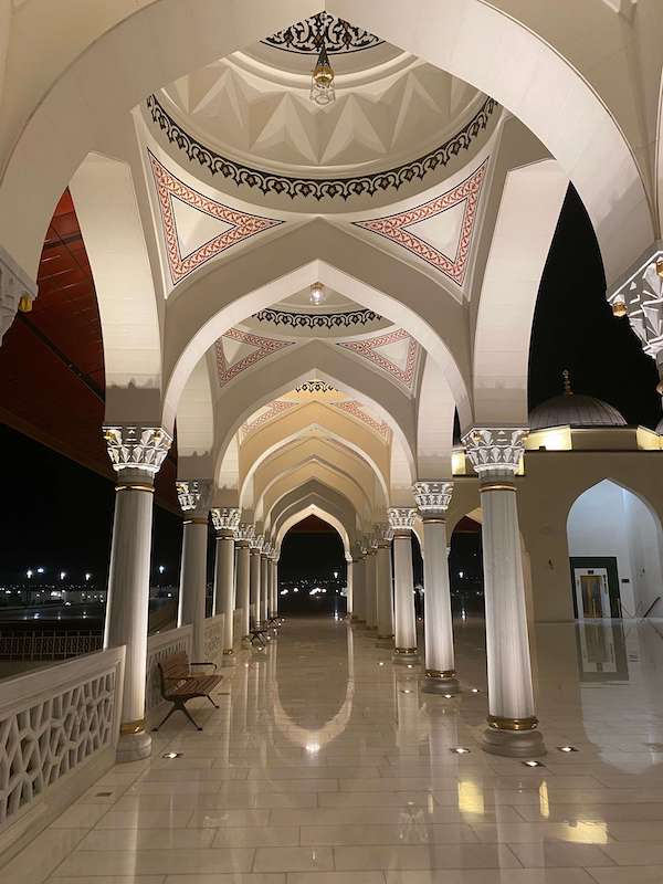 arches sharjah mosque at night
