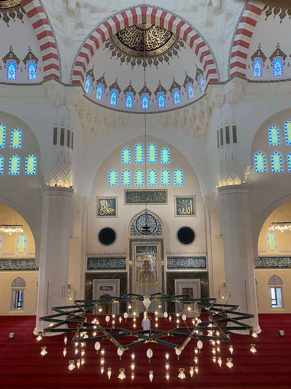 interior sharjah mosque in cream and gold and with a chandelier