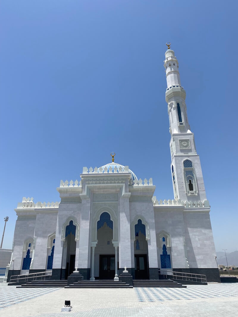 white mosque with blue dome