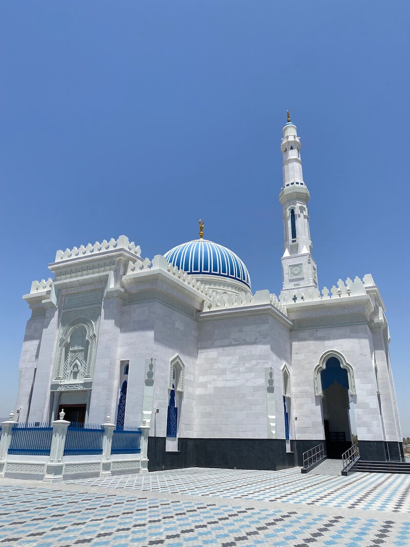 white mosque with blue dome