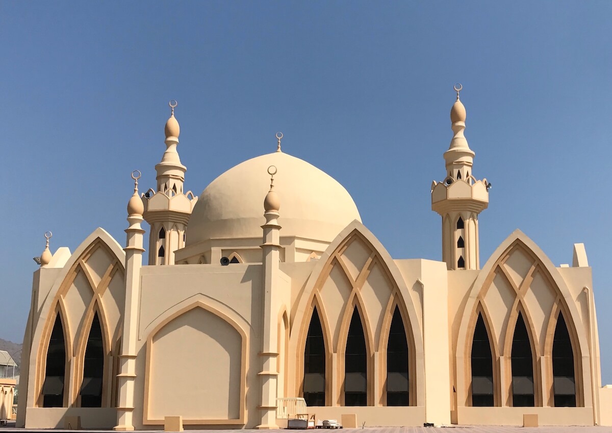 Mosque with arched windows with interlacing arch design and 
dome and minarets 