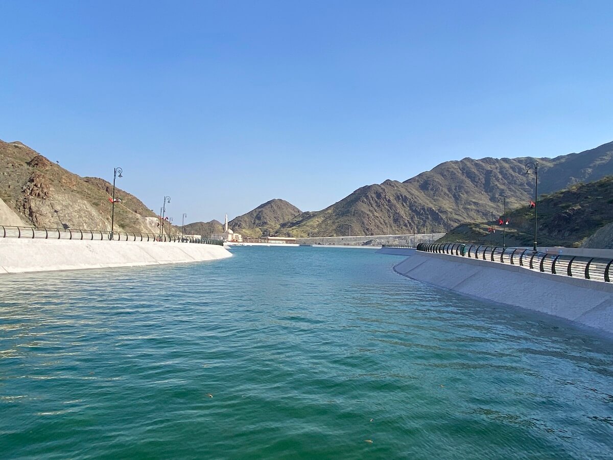 view of reservoir with concrete walls and mountains in background