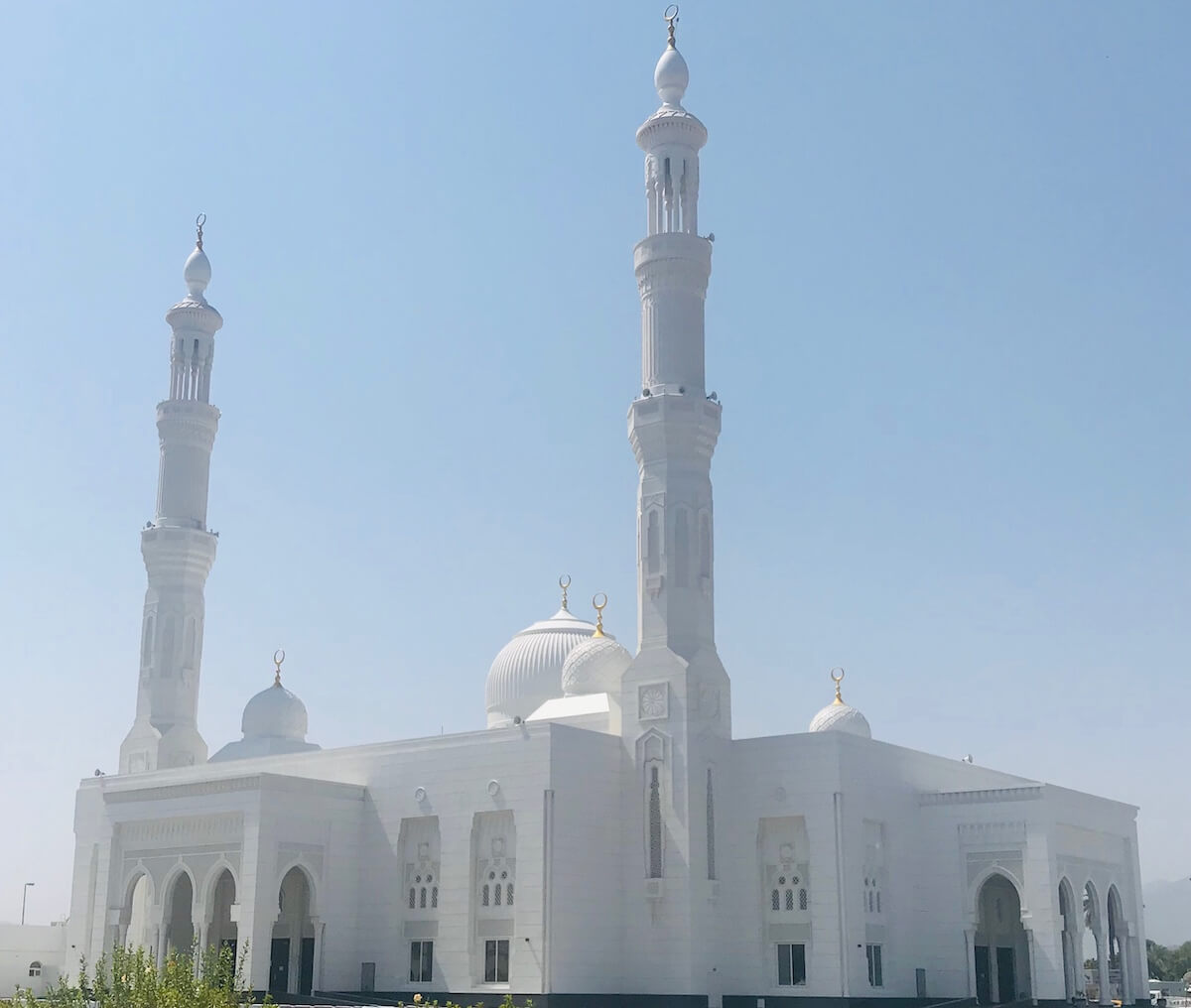 all white mosque with dome and minarets