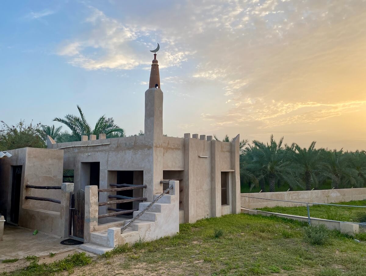 small simple mosque on farm with small minaret