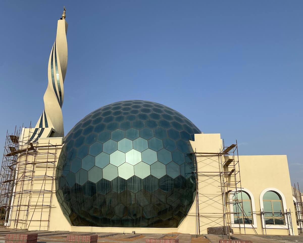 Mosque with Globe shaped glass prayer hall and twisted minaret