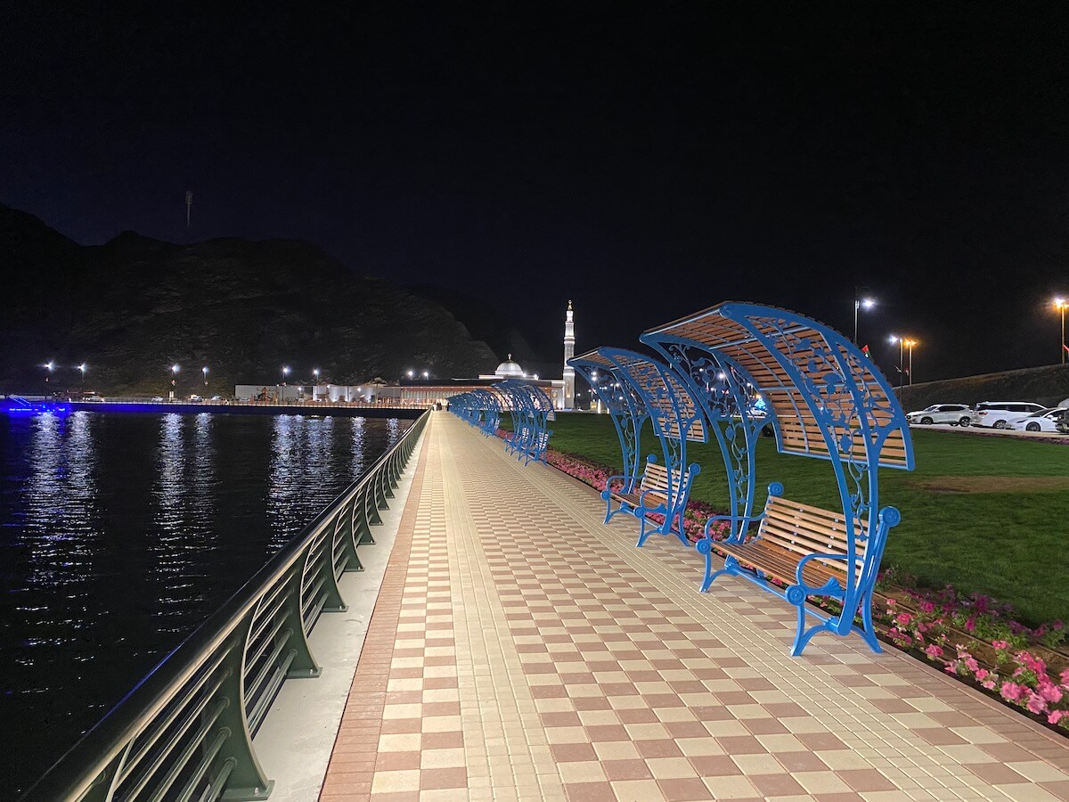 walkway around lake and benches, at night